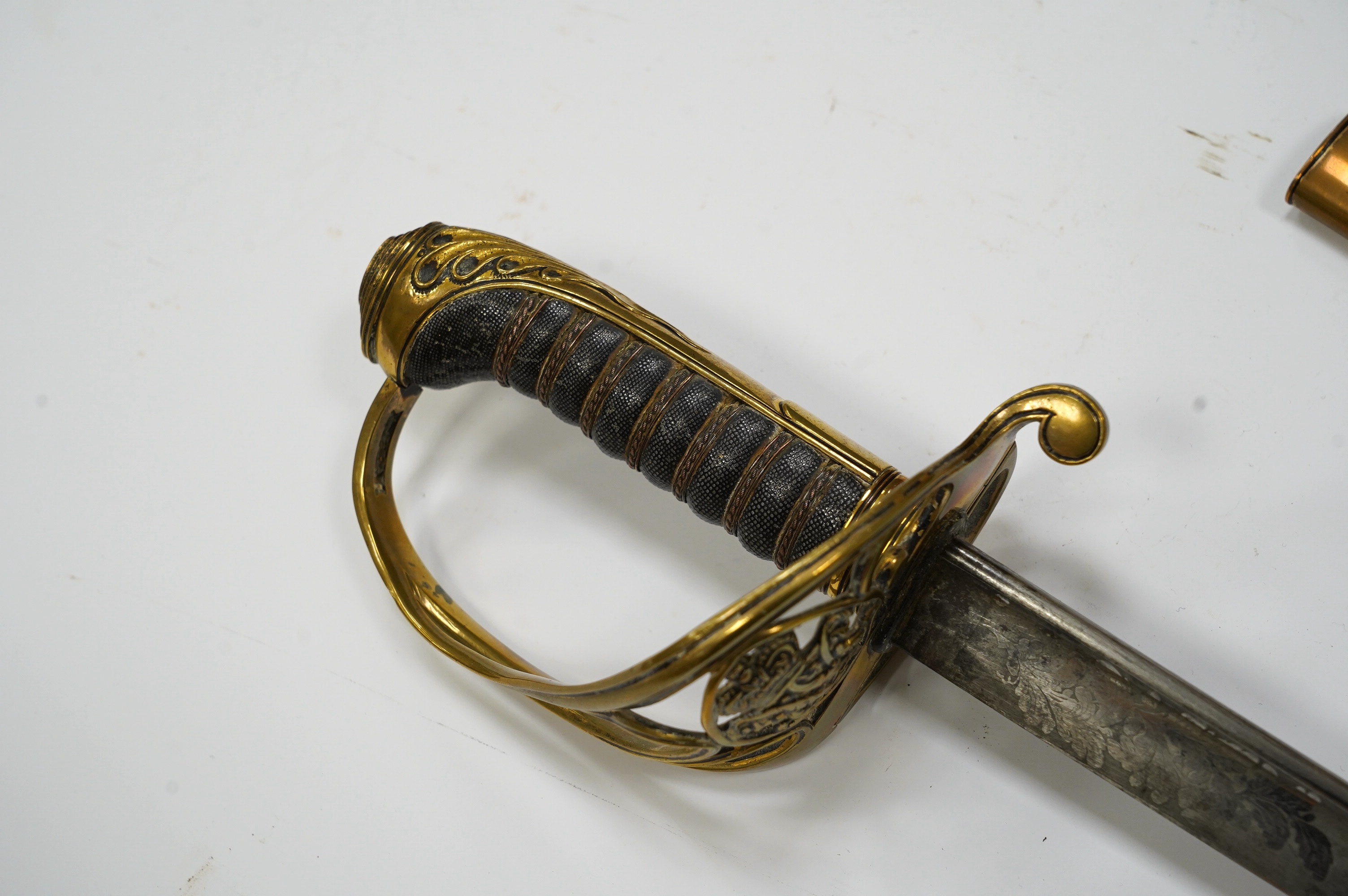 An early 19th century officer's sword, William IV cypher to knuckle guard, folding knuckle guard, engraved curved blade with William IV cypher and makers signature; ‘Vernon 4 Charing Cross London’, leather scabbard with